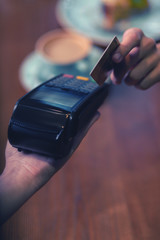 My credit card. Young woman holding card while doing payment