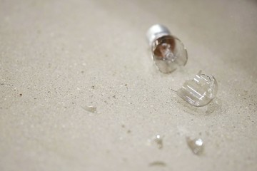Glass fragments of broken bulbs scattered on concrete floors.