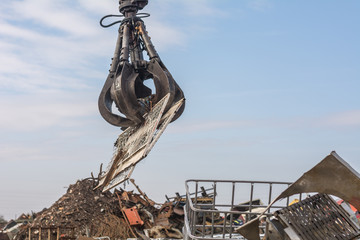 Large tracked excavator at a metal recycle yard
