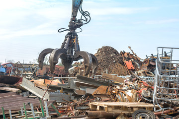 Large tracked excavator at a metal recycle yard