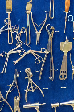 Gynecological instruments on blue background. vertical photo.