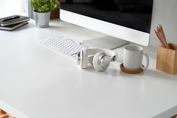 White workspace with modern desktop computer and office accessories