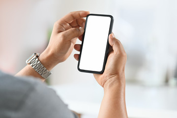 Man using smart phone over blurred bright background