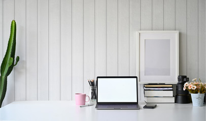 Workspace with blank screen laptop.