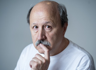 Close up portrait of sad old man face suffering from depression