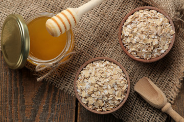 Dry oatmeal, honey and oatmeal cookies. food. healthy food. on a brown wooden table. top view