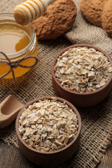 Dry oatmeal, honey and oatmeal cookies. food. healthy food. on a brown wooden table.