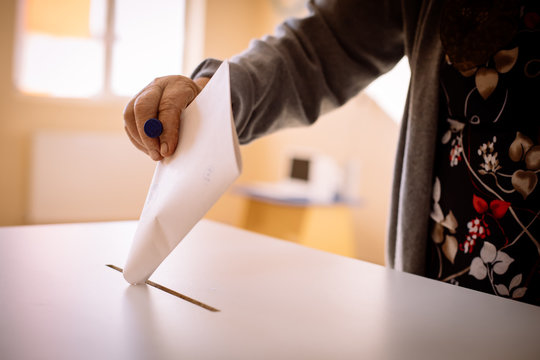 Person voting, casting a ballot
