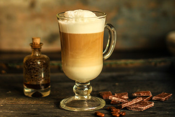 Latte - a cup of coffee with milk in a transparent cup on the table. top view.