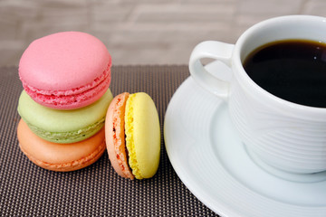 macaroons and cup of coffee on white background