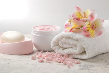 Obraz na płótnie Canvas Spa composition with soap, towel and body scrub. spa concept. on a light background.