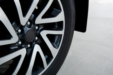 closeup alloy car wheels with soft-focus and over light in the background
