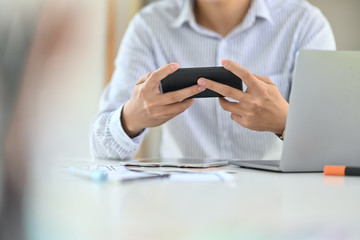 Fototapeta premium Businessman using a mobile phone in office