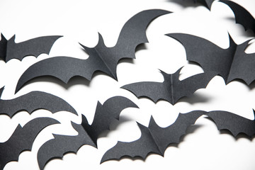 Halloween paper bat decorations on a white background.