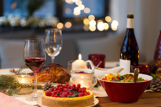 christmas dinner and eating concept - food and drinks on table at home