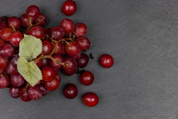 Ripe red grape on the dark background