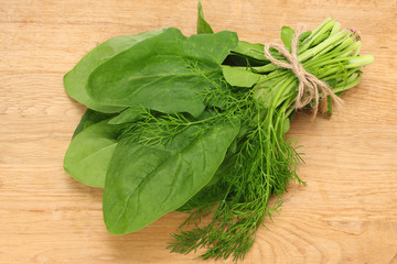 spinach leaves on wooden background. Healthy food. Top view.