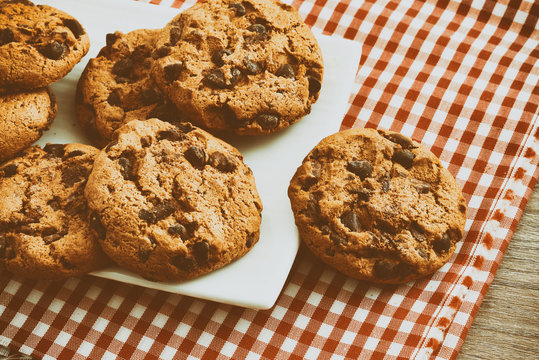 Round biscuits with black chocolate close up vintage