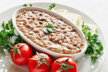 lobio served with tomatoes, parsley and cheese