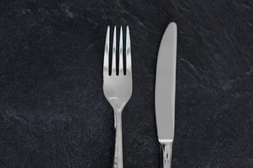 table setting, cutlery and eating concept - close up of fork and knife