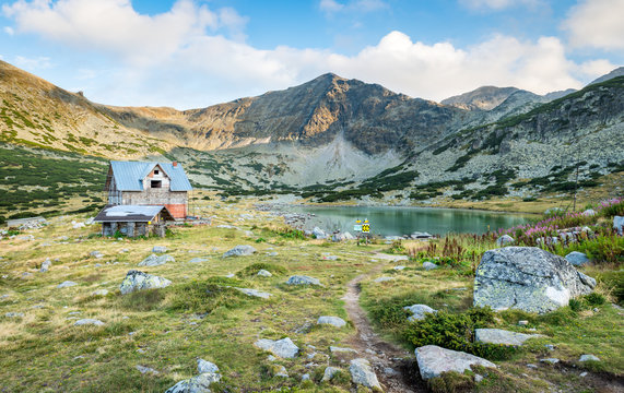 Panoramic view of Musala mountain with a lake and a hut under