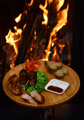 Shashlik or shish kebab on wooden board. Shashlik grilled meat skewered on sticks traditional georgian dish at burning fire. For hungry people