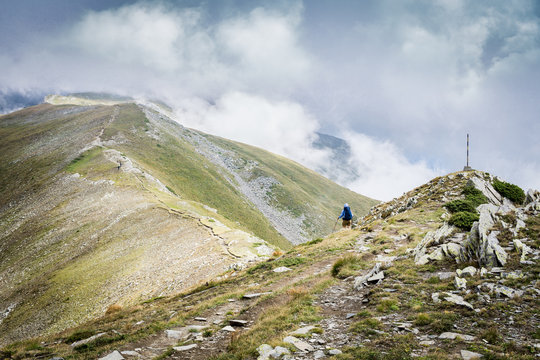 Hiker climbing Malyovitsa peak in Rile Mountain, Bulgaria