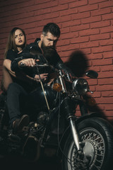 Fototapeta na wymiar Couple of bikers on motorcycle ready to travel. Hipster and woman sit on retro motorbike, travel concept. Just go