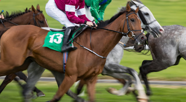 panning motion blur on galloping race horses and jockeys