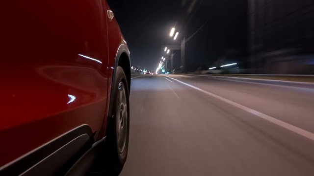 Drivelapse urban look from fast driving car at a night avenue in a city timelapse hyperlapse