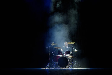 music, people, musical instruments and entertainment concept - male musician with drumsticks...