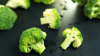 Fresh broccoli on black background.