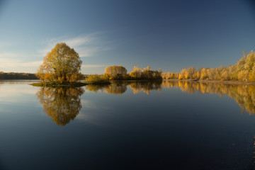 Soft autumn landscape, reflected in calm water