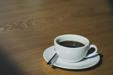 Coffee cup of hot  with  on wooden floor place for message.