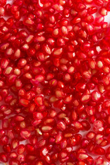 Ripe red pomegranate seeds. Full background
