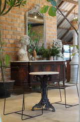 Black hand made chair wrought iron and antique table,  indoor furniture in the restaurant.