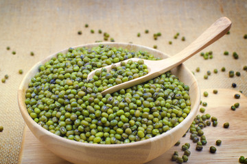 Green bean or mung bean in bowl and sack background.