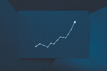 exponential graph. growth improvement progress concept. arrow pointing upward on teal blue paper.