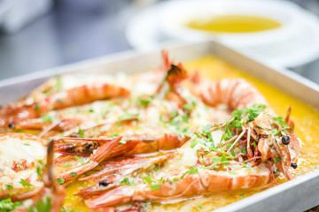 Baked tiger shrimps in a butter sauce with herbs