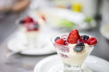 Glass bowl full of ice cream and fruit