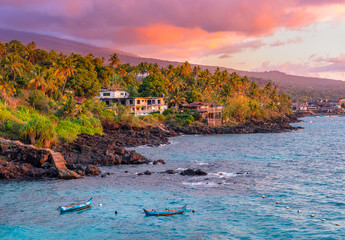 Sunset boats in holiday paradise resort on Grand Comore island, Comoros. Beautiful sunset light of...