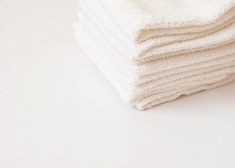Fototapeta na wymiar white towel on blue background . White Spa towels on blue background, top view