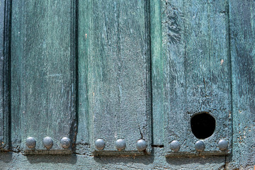 Old wooden door with hole for cat pets