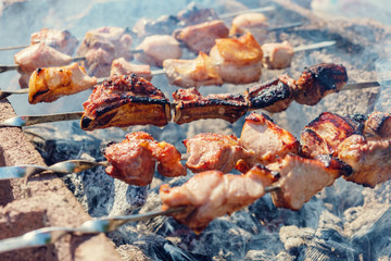 Skewers fried meat on a grill
