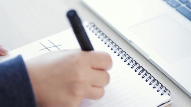 woman writing me too on a notebook