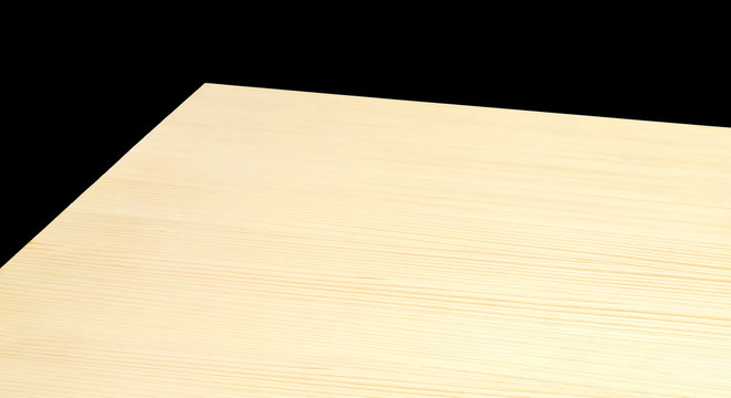 Perspective view of empty light maple wooden table on black background including clipping path