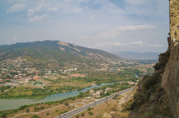 Fototapeta na wymiar Beautiful view of the Aragvi river from the Jvari Monastery standing on the rocky mountaintop. Georgia, Mtskheta-Mtianeti, Mtskheta