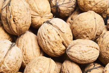 Walnut background, scattered pile of walnuts