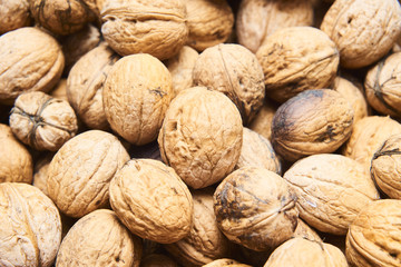 Walnut background, scattered pile of walnuts