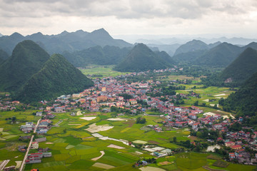Fototapeta na wymiar Bac Son mountain from top view to a small town and rice field in Vietnam